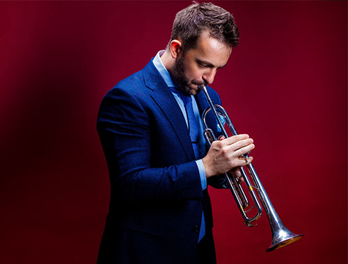 Image a man playing the trumpet